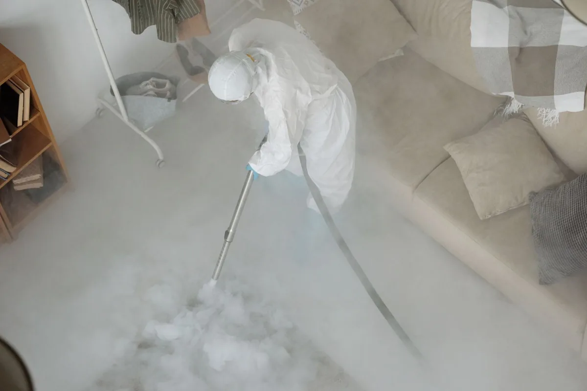 Biohazard cleanup technician in protective equipment, St. George, KS